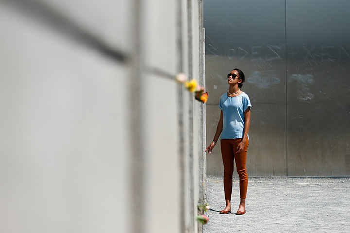 Malia and Sasha Obama: Malia Obama looks up to remains of the Berlin Wall