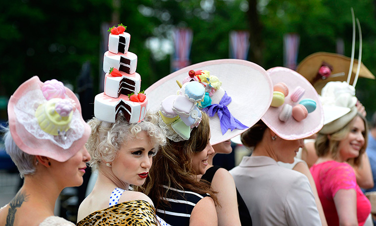 Ladies day at Ascot: Racegoers pose for photographers as they arrive for Ladies Day