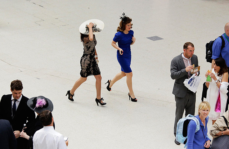 Ladies day at Ascot: Women race across the concourse at Waterloo Station 