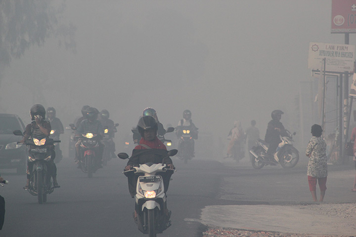 Singapore smog: Indonesian motorists travel under a blanket of haze in Pekanbaru city, Suma