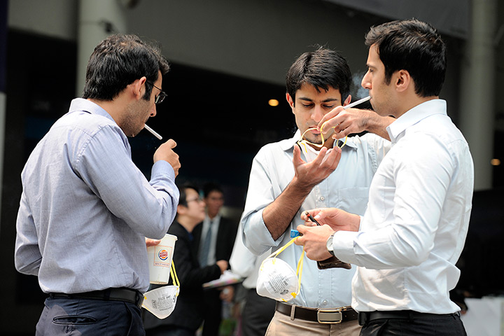 Singapore smog: People smoke in the street before putting on masks in Singapore