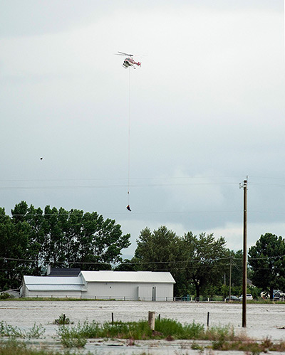 Canada floods: A person stranded on the roof of a vehicle is airlifted to safety by a heli