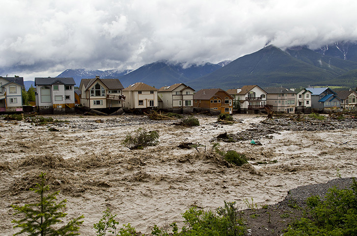 Canada floods: Houses damaged along the edge of Cougar Creek are  in Canmore, Alberta