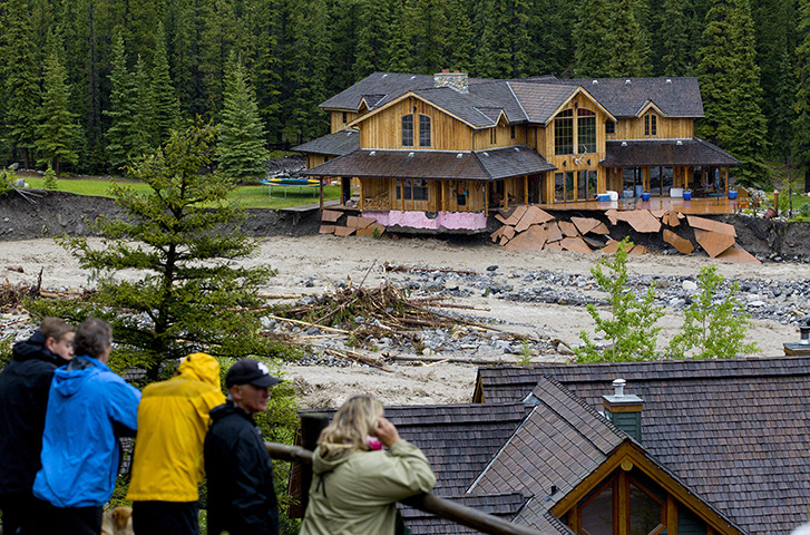 Canada floods: Residents watch flooding along Cougar Creek in Canmore, Alberta