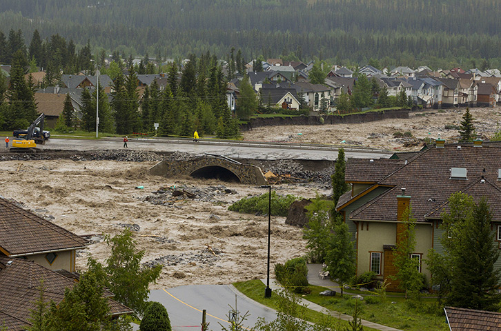 Canada floods: Cougar Creek takes out Eagle Terrace Road and breaches Elk Run Blvd Bridge 