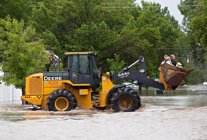 Canada floods: A tractor carries residents after they were rescued from the flood waters i