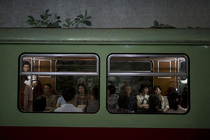 20 Photos: Commuters ride on a subway train at Yonggwang station in Pyongyang