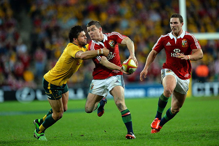 Lions gallery: Brian O'Driscoll tries to pass around Adam Ashley-Cooper 
