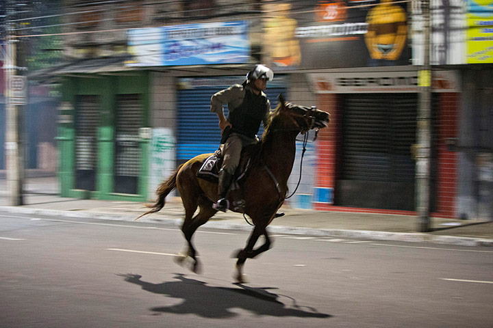 Brazil Protests: A Brazilian mounted police officer charges in Fortaleza, Brazil 