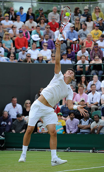 Tom Wimbo day 2: Bernard Tomic serves during his 5 set victory over Sam Querrey 7-6, 7-6, 3-