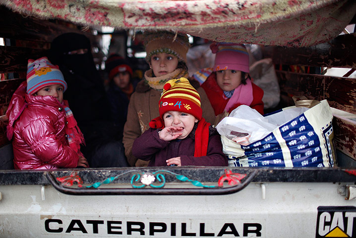 Syrian refugees: A Syrian toddler cries as she arrives at a refugee camp