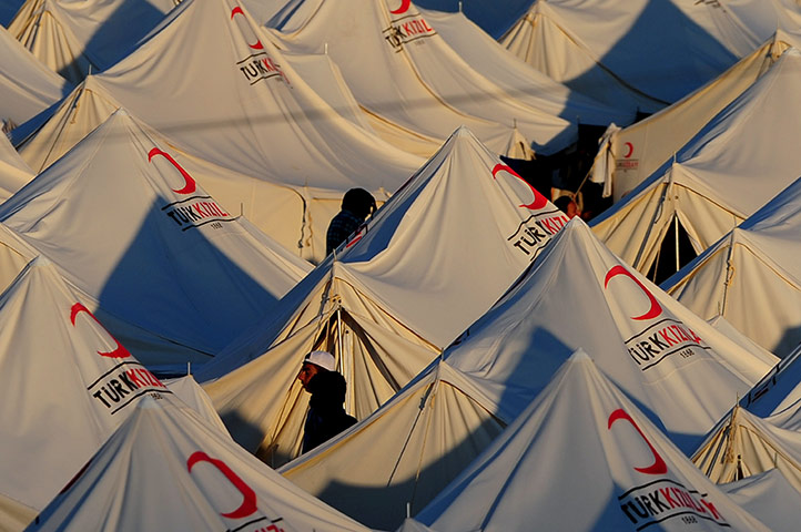 Syrian refugees: Syrian refugees walk in the Boynuyogun camp