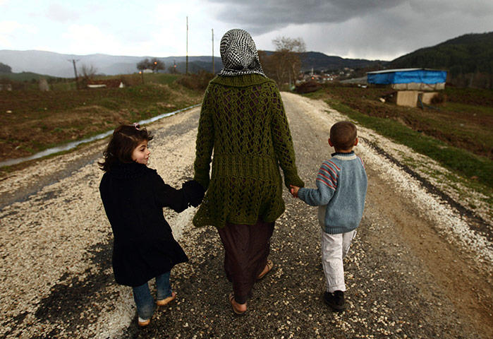 Syrian refugees: Sawssan Abdelwahab, who fled Idlib in Syria, walks with her children