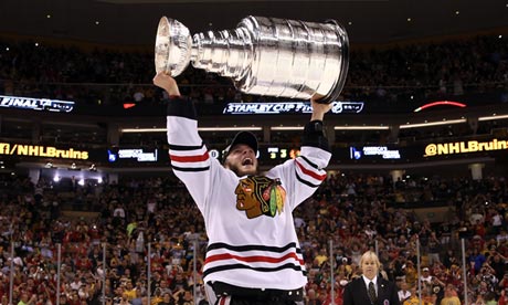 Jonathan Toews of the Chicago Blackhawks hoists the Stanley Cup Trophy