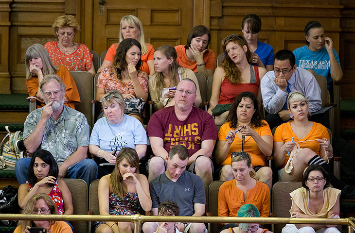 Pro-choice activists watch Texas senator Wendy Davis's filibuster of an abortion bill