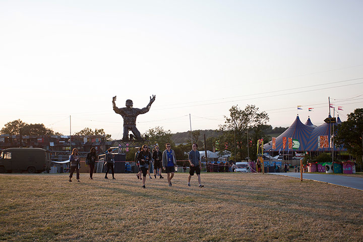Glastonbury: Festival staff wander through the grounds on Tuesday afternoon