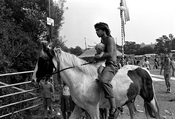 Glastonbury 80s: Man with baby on horse