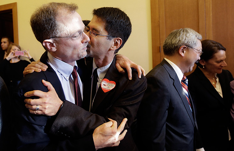 Gay marriage : John Lewis gets a kiss from his partner Stuart Gaffney as they embrace at C