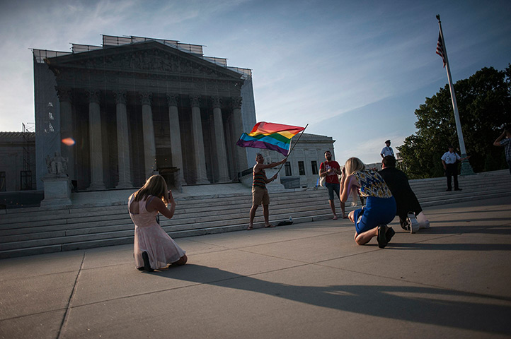 Gay marriage : A demonstrator waves a flag while awaiting decisions at the US Supreme Cour