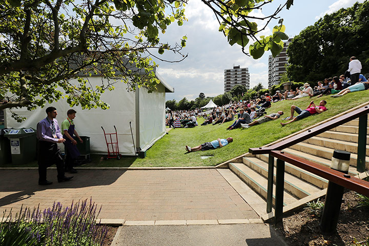 Sleepers at Wimbledon: A man sleeps on the grass
