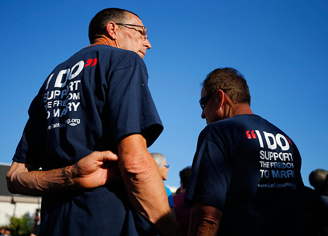 gay rights: Two men attend a rally in support of the US court decision on marriage