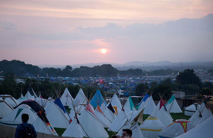 Glastonbury: Sun sets over Glastonbury for the first night of camping