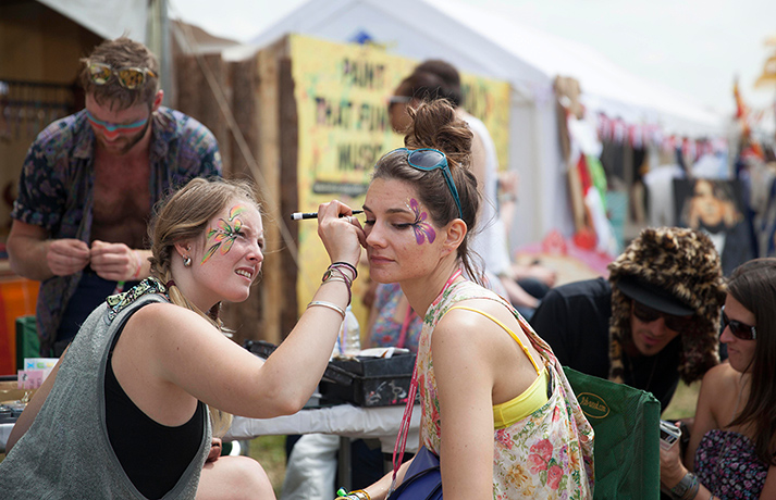Glastonbury: A festival goer has her face painted