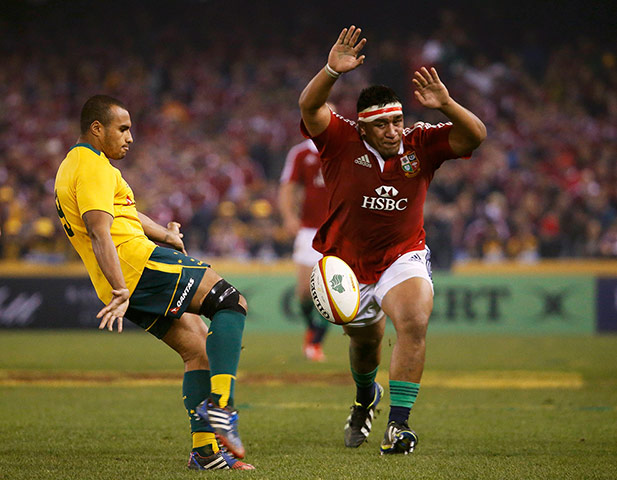 lions gallery 4: Mako Vunipola attempts to charge down a kick from Will Genia