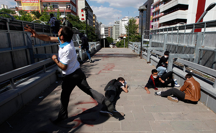 Turkey protests: Protesters take cover during clashes with riot police