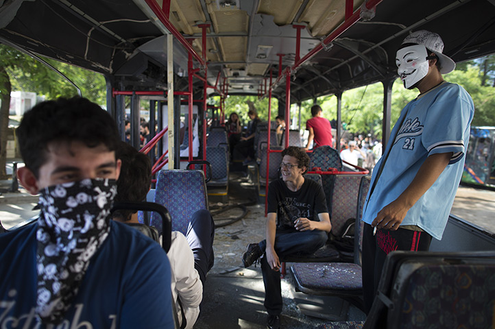 Turkey protests: Protestors sit in a damaged bus in Taksim Square in Istanbul
