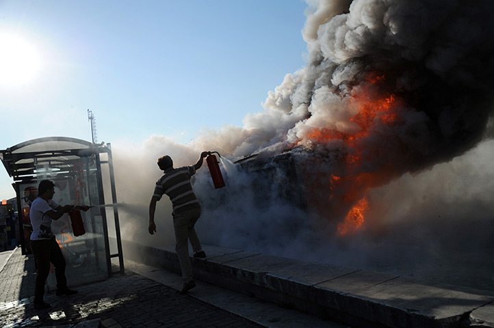 Turkey protests: A Police car set alight in Taksim square, Istanbul