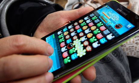 Commuter plays a game with a smartphone