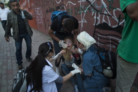 A protestors is treated after she was hit by tear gas during clashes with Turkish police near Turkish Prime Minister Recep Tayyip Erdogan's office, between Taksim and Besiktas on June 3, 2013 in Istanbul, Turkey.