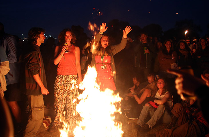 nightlife: People dance around a fire that has been lit inside the stone circle as peo