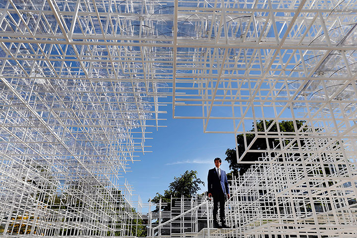 Serpentine pavilion: A broadcast journalist stands inside pavilion