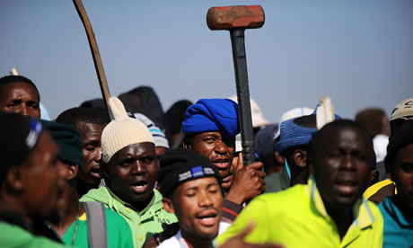 Striking Lonmin mine workers gather during industrial action last month