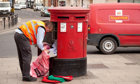 A postman emptying mail from a mailbox