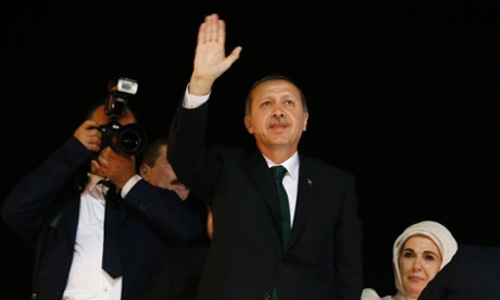 Tayyip Erdogan waves to supporters after arriving in Istanbul early on Friday morning.