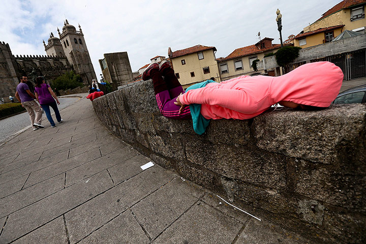 Urban bodies: A performer lies on a wall