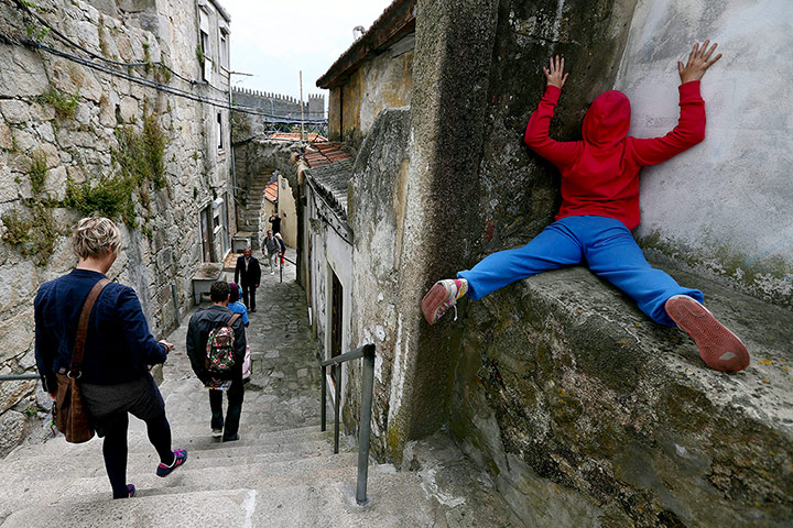Urban bodies: A performer against a wall