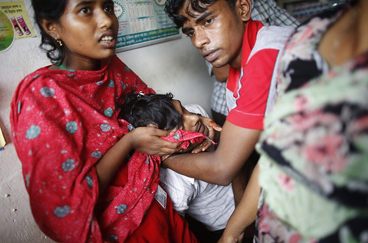 20 Photos: Garment workers look after a colleague injured by rubber bullets in Dhaka