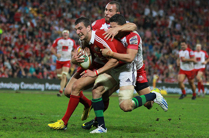 British & Irish Lions v Reds: Sam Warburton is tackled by Quade Cooper and Anthony Fainga'a