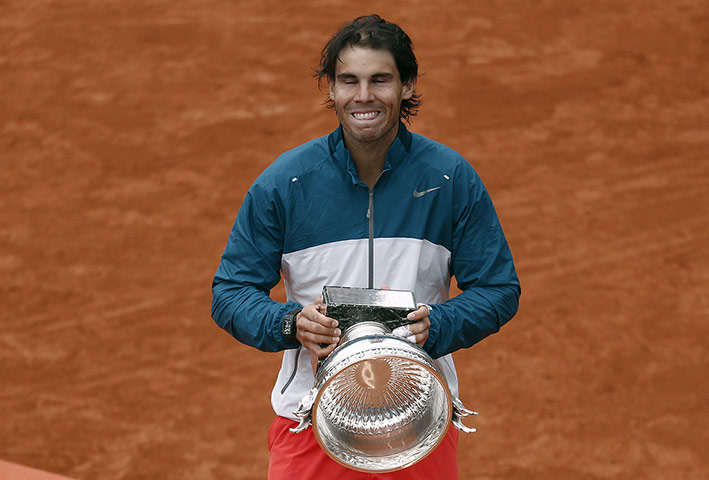 tennis7: Spain's Rafael Nadal celebrates with the trophy following his victory over 