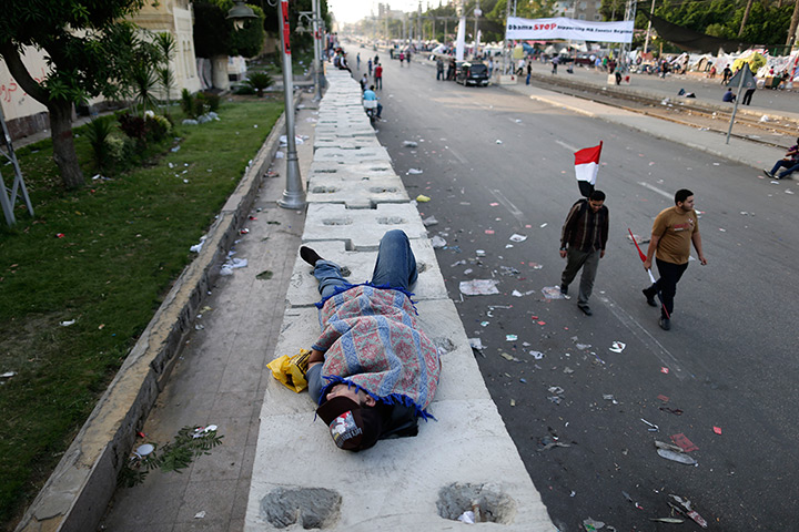 Egypt protest: An opponent of Morsi sleeps outside the presidential palace