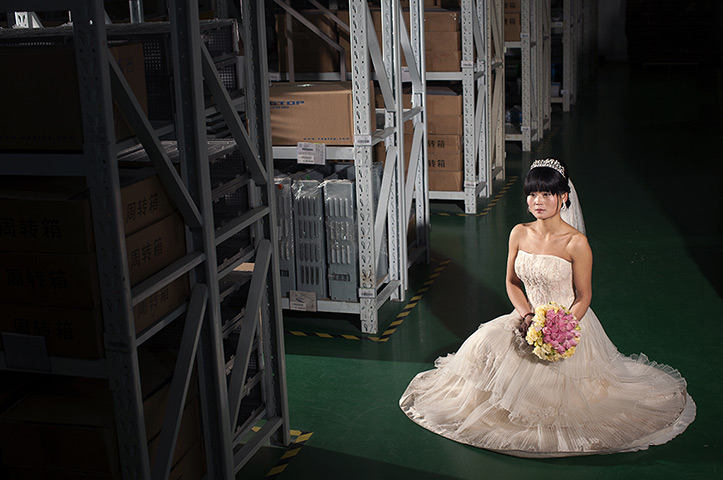 Love on the assembly line: Xue Zhang poses at the Shanghai Ying Feng Industrial Co. In 2012, she disco