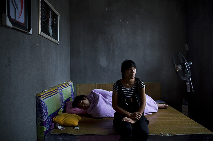 Love on the assembly line: Guang Xia and his wife Qianqian Li pose for a photo in August 2012 in Shang