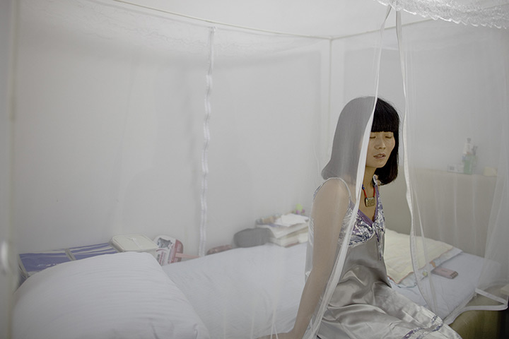 Love on the assembly line: Xue Zhang poses for a photo in August 2012 in Shanghai. Although Xue doesn'