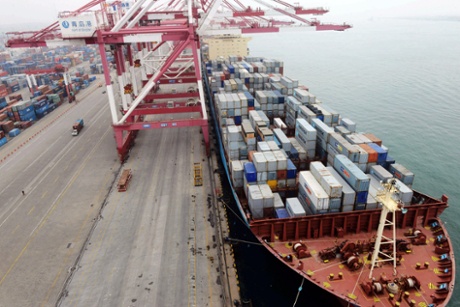In this photo taken Monday July 8, 2013, a ship is docked at a container port in Qingdao in eastern China's Shandong province.
