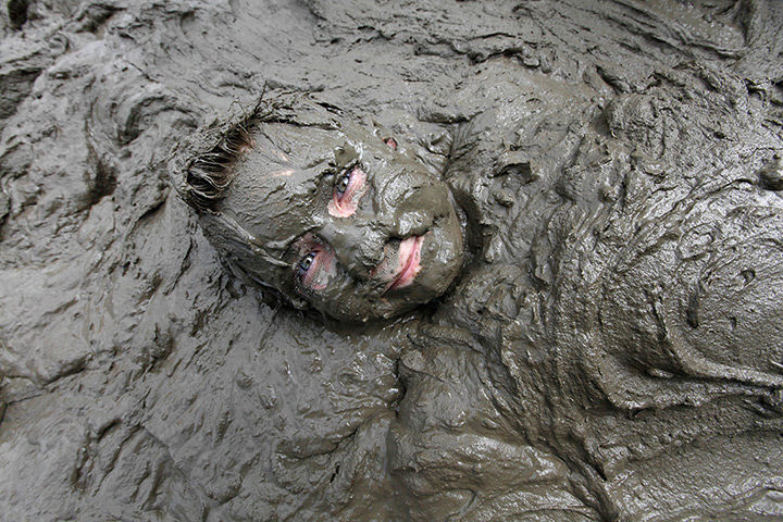 Annual mud day: Zach Miller, 10, of Livonia lies in mud 
