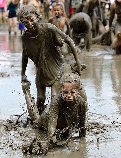 Mud day: Stephanie Strong, 9, standing, helps Grace Lipscomb, 10, both of Howell, wh